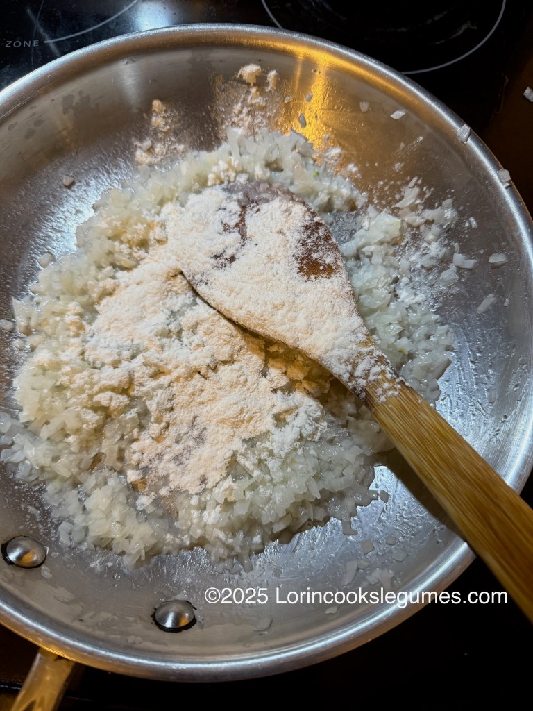 A pan with sautéed onions and flour mixed together, showing the process of making a roux for a Slovak bean soup.
