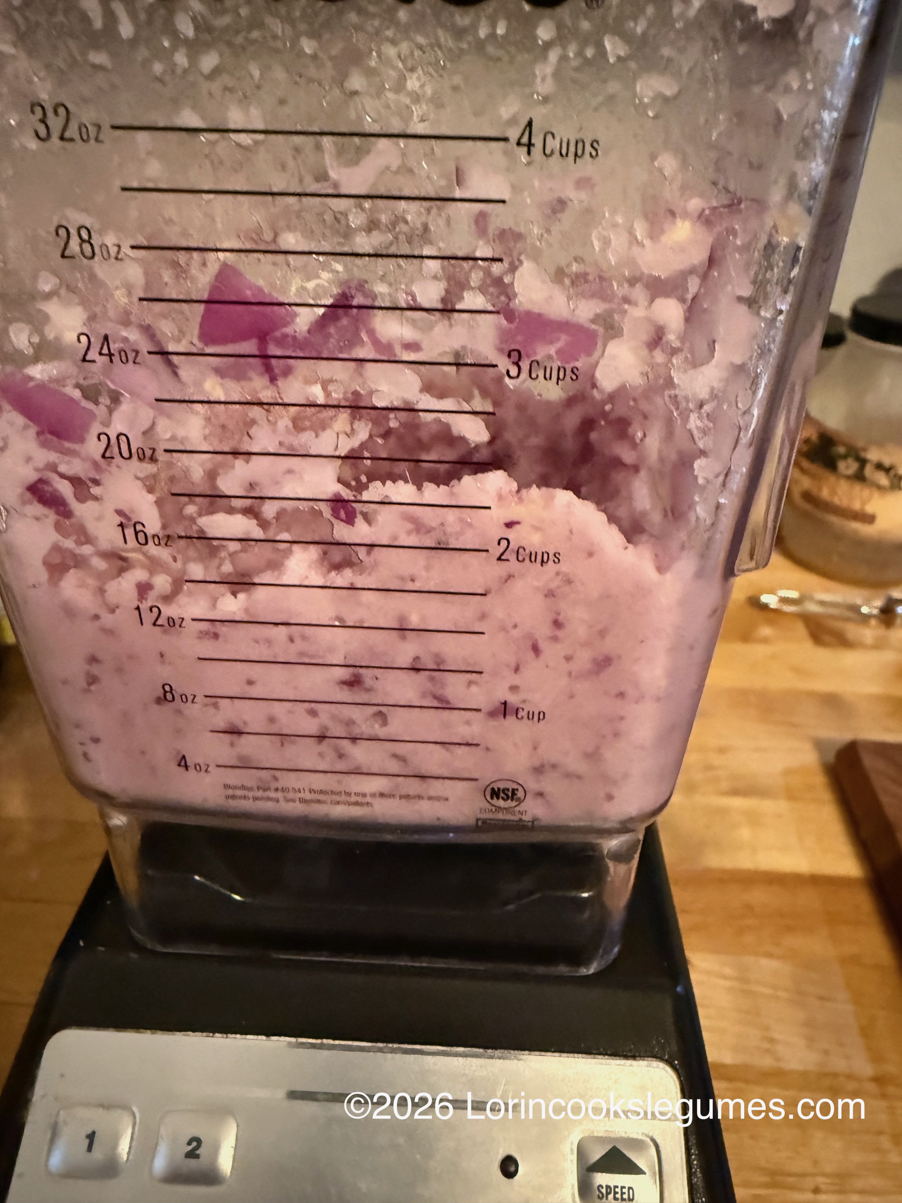 Blender container with a pink red onion purée inside