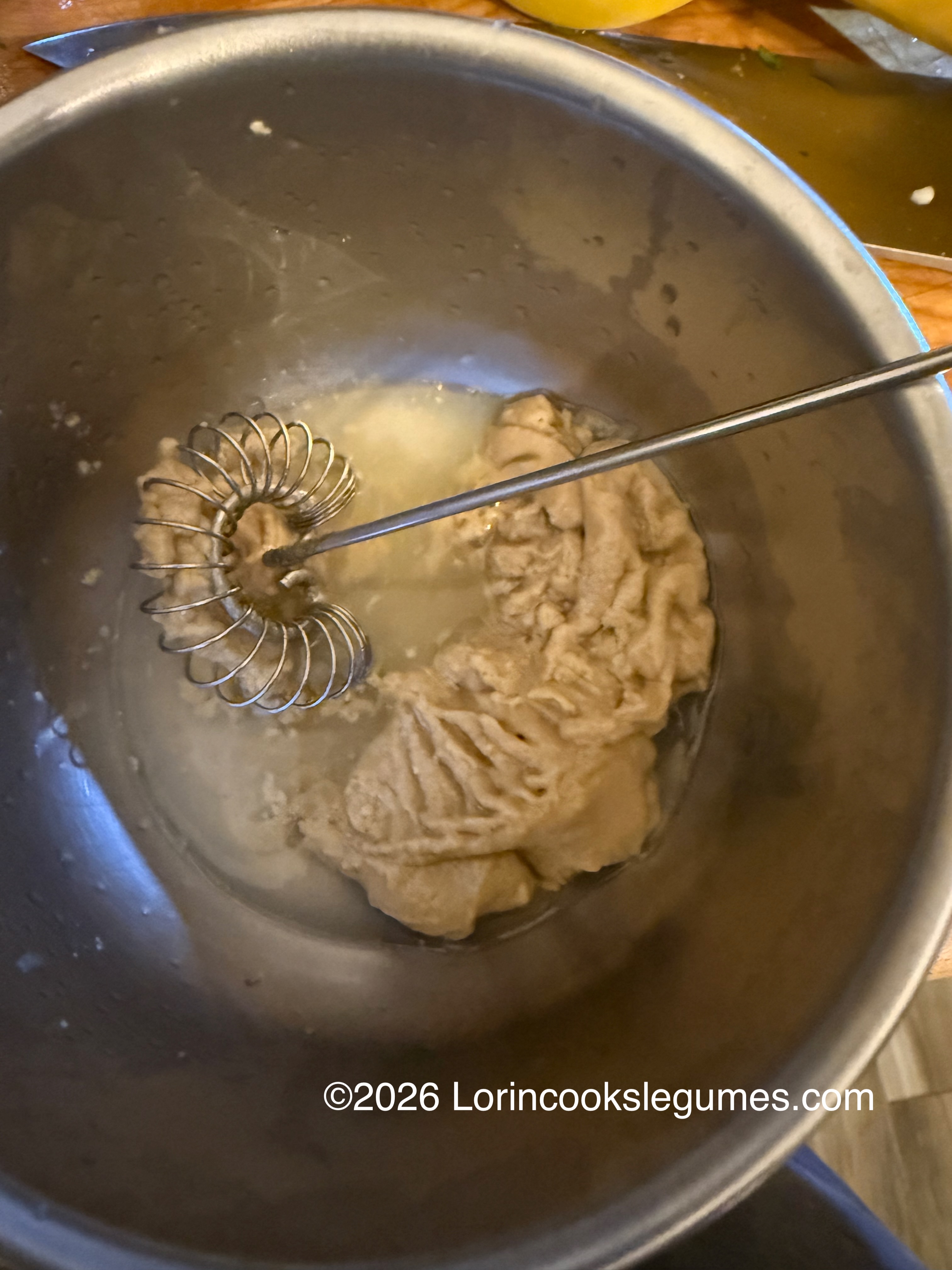 IMG_9953 Metal bowl with scoop of tahini and a spiral whisk inside