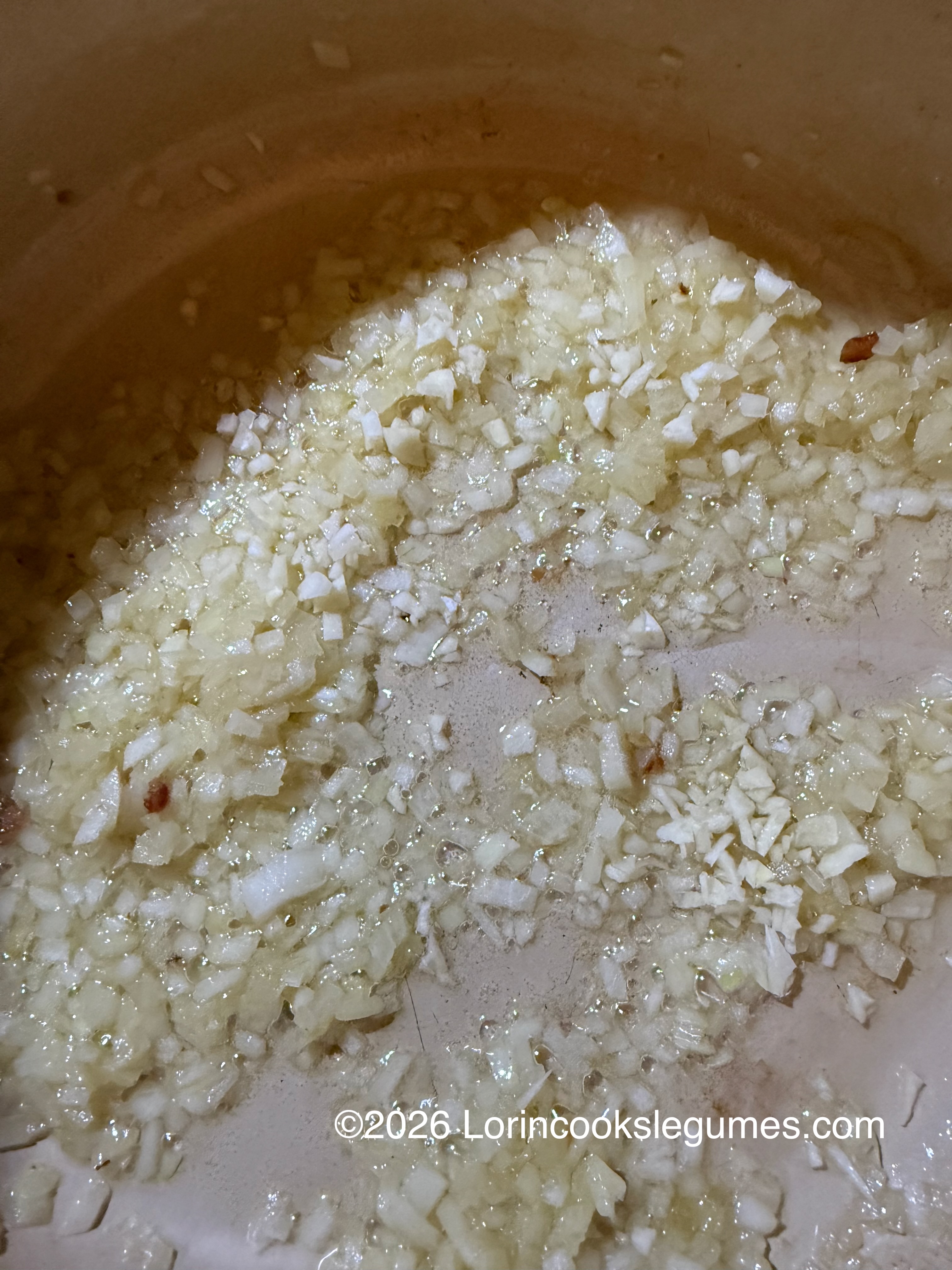 Finely chopped onions sautéing in oil in a pan