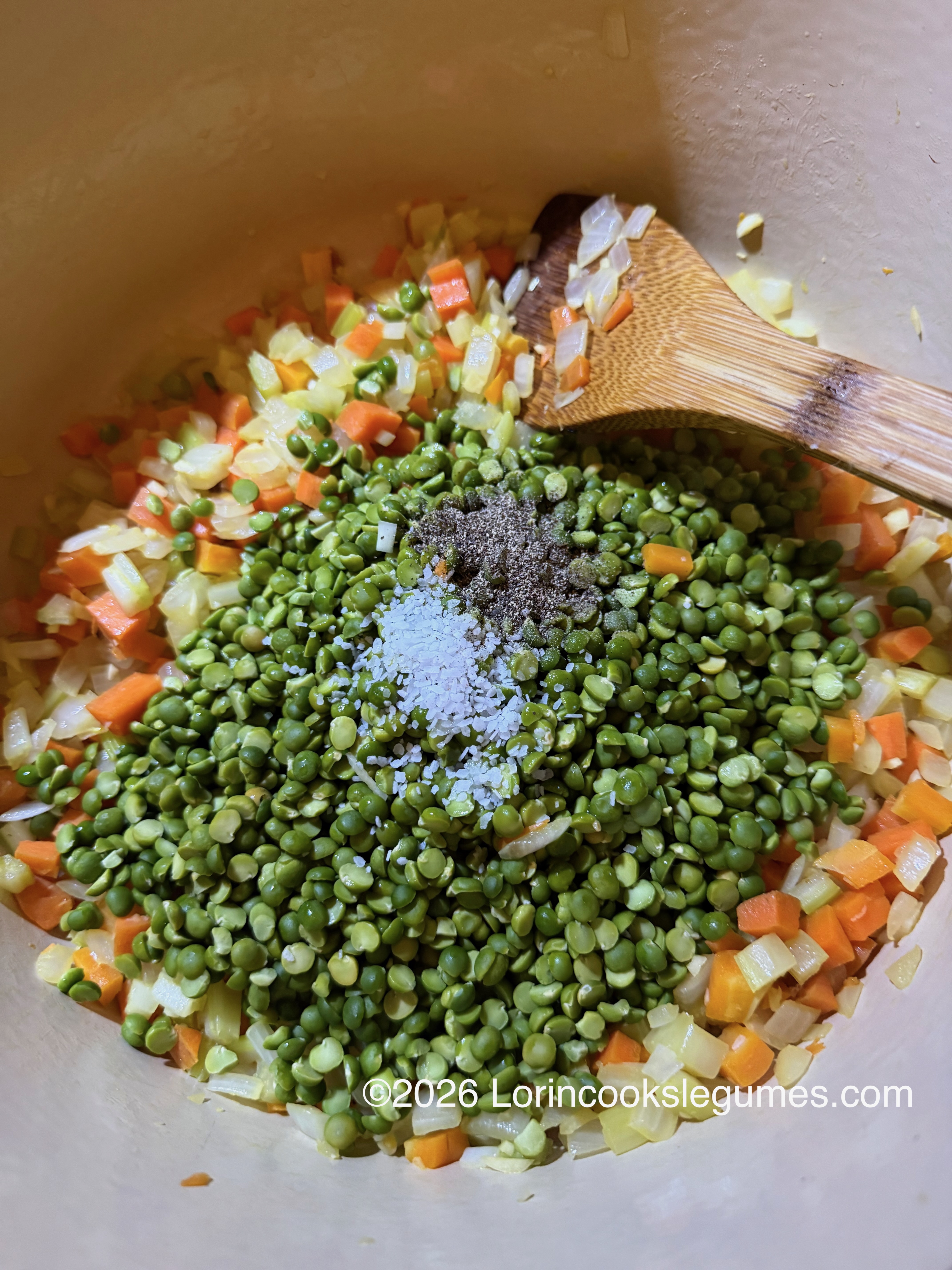 Close-up of split peas with diced carrots, onions, and celery, salt and pepper