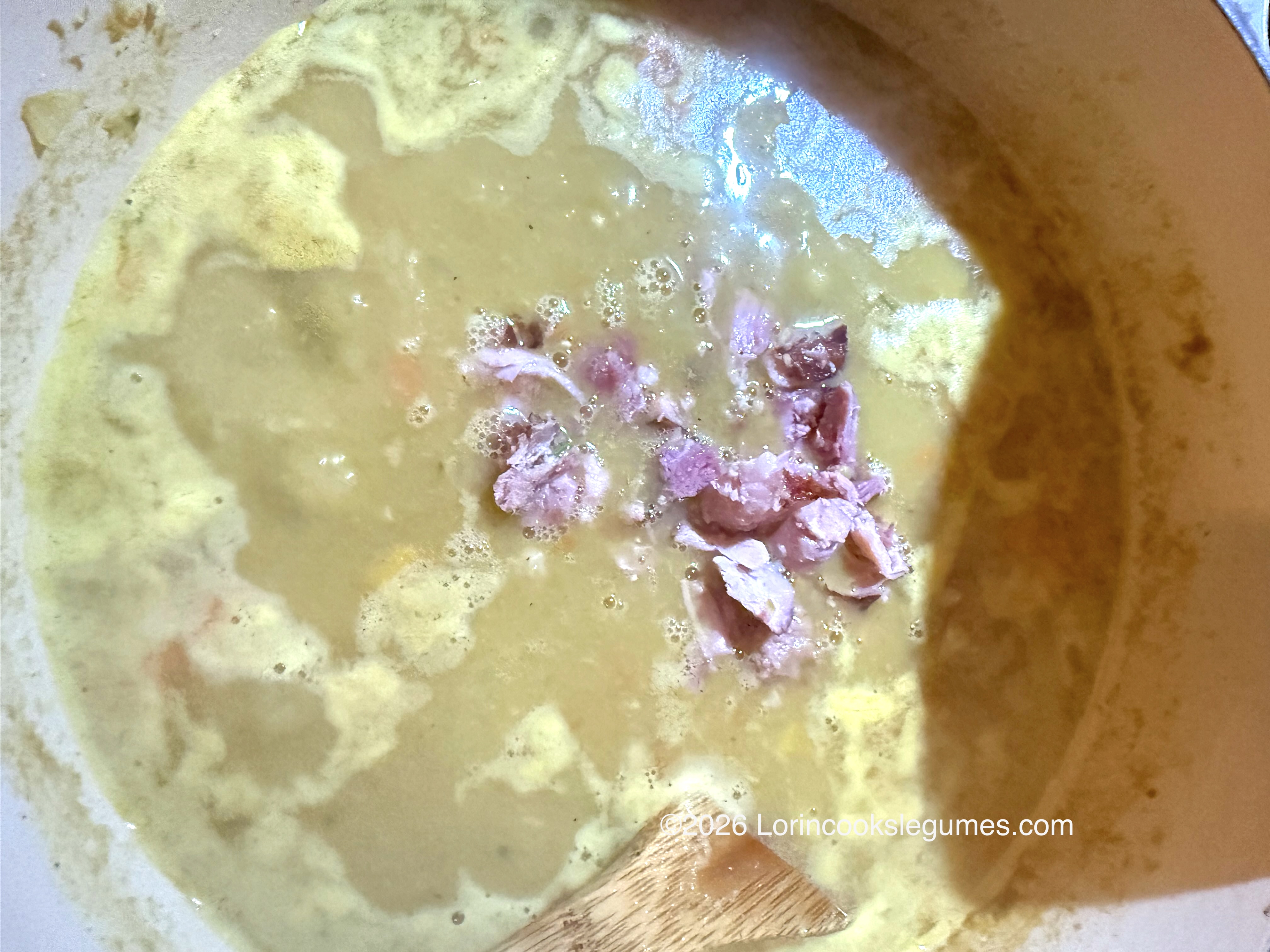 Close-up of pale green split pea soup with ham; ©2026 Lorincookslegumes.com